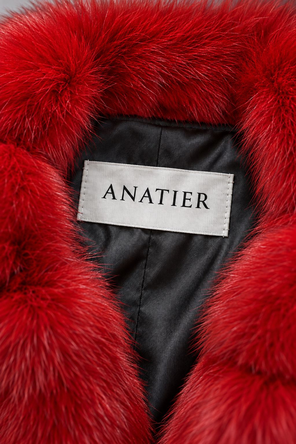 The Anatier label stitched inside the red fox fur coat
